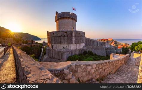 Old city walls with sight on Minceta Tower and Old Harbour of Dubrovnik at sunrise in Dubrovnik, Croatia. Minceta Tower in Dubrovnik, Croatia