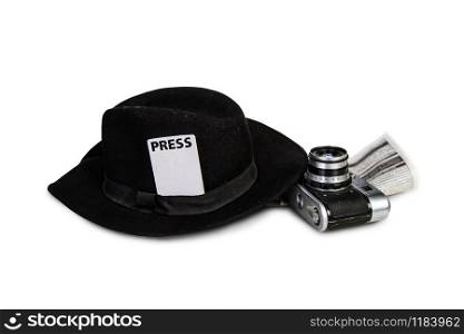 old classic fedora hat with attached press badge and film camera on white background