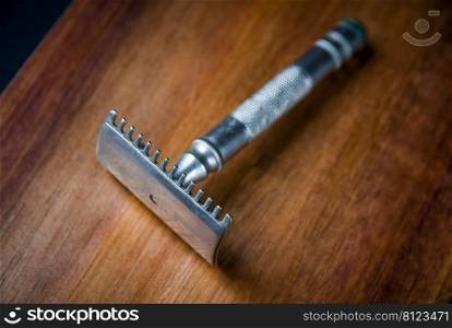 Old classic vintage shaver razor on a wooden background. Old vintage shaver on a wooden background