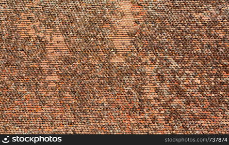 Old clay tiles on the roof background