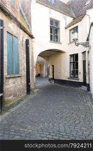 Old Cobbled Street With Arch in Bruges, Belgium