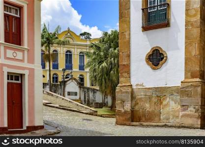 Old cobblestone street with houses in colonial architecture in the famous city of Ouro Preto in Minas Gerais. Old cobblestone street with colonial style buildings