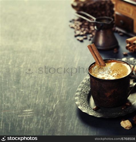 Old coffee cup and mill on dark rustic background