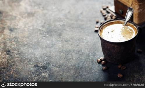 Old coffee cup and mill on dark rustic background