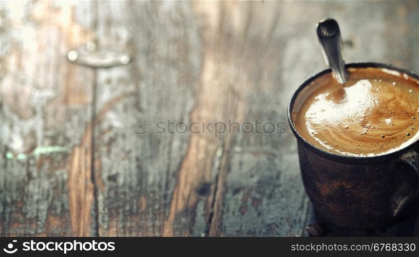 Old coffee cup on dark rustic background