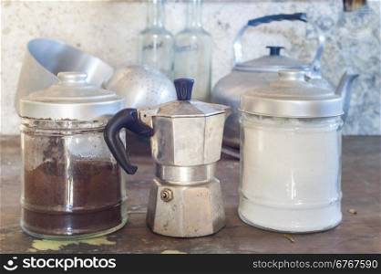 Old coffee maker with two old cans for sugar and coffee