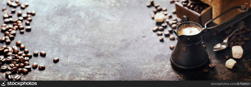 Old coffee pot and mill on dark rustic background