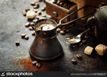 Old coffee pot and mill on dark rustic background
