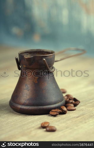 Old coffee pot on blue rustic background