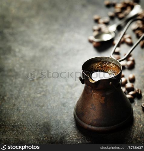 Old coffee pot on dark rustic background