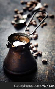 Old coffee pot on dark rustic background