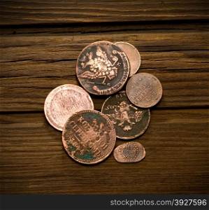 old coins of Russian Empire in the background of old weathered wood