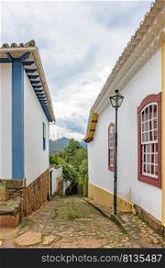 Old colonial-style alley with cobblestone street in the historic city of Tiradentes in Minas Gerais. Old alley with cobblestone street in the historic city of Tiradentes 