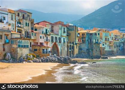 Old colorful houses by the sea in Cefalu town in Sicily, Italy