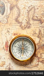 Old compass on ancient map. A compass with the antique image of a direction