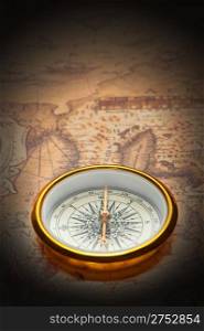 Old compass on ancient map. A compass with the antique image of a direction