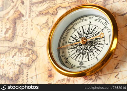 Old compass on ancient map. A compass with the antique image of a direction