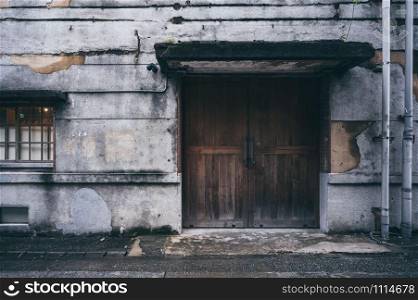 old concrete wall with vintage wooden door