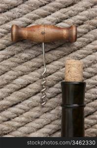 Old corkscrew and bottle of wine