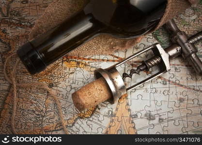 Old corkscrew and bottle of wine