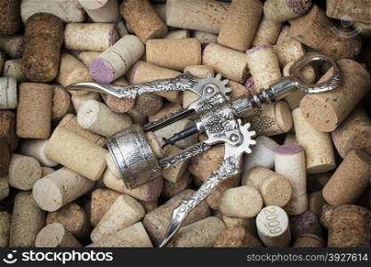 Old corkscrew on many wine corks