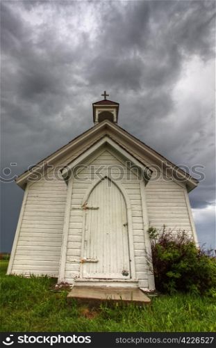 Old Country Church in Saskatchewan Canada with storm clouds