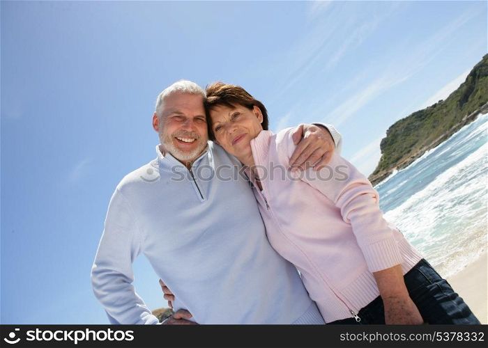 Old couple at the beach enjoying their retirement