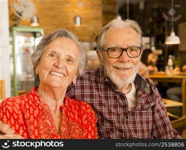 Old couple at the restaurant and having a good time