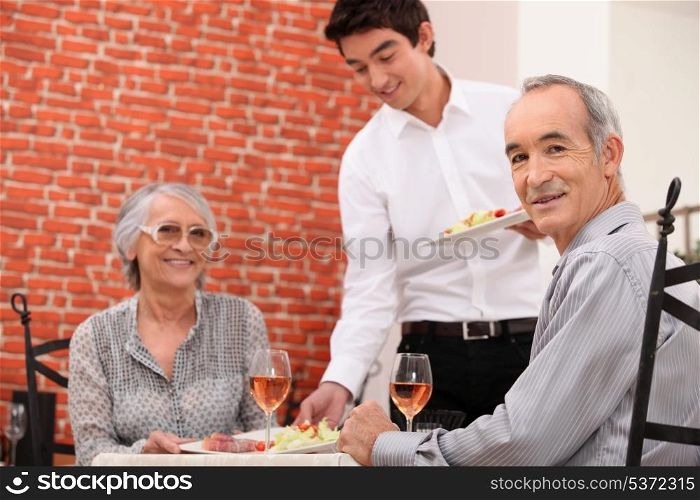 Old couple having meal in restaurant