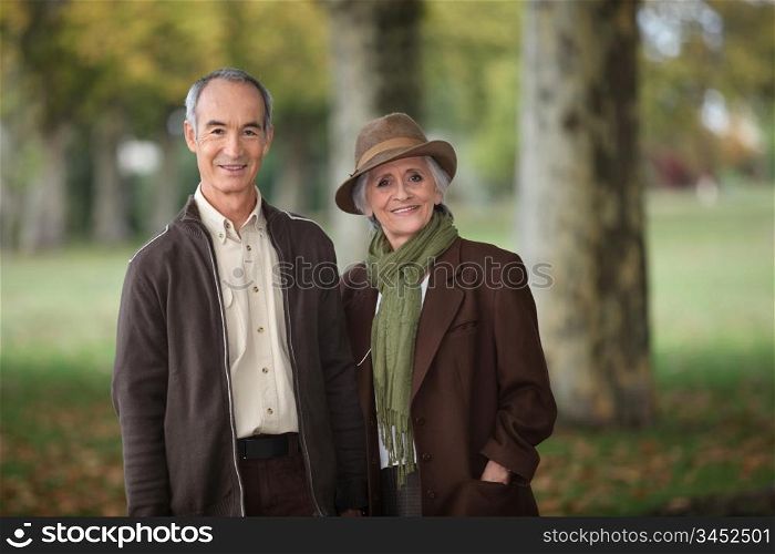 old couple in a park at autumn season