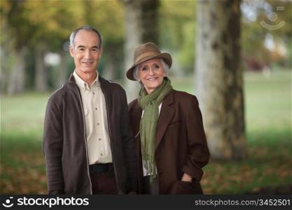 old couple in a park at autumn season