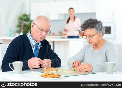 Old couple playing a board game