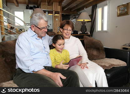 Old couple sat with their granddaughter