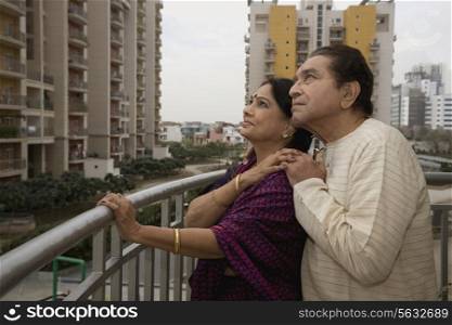 Old couple standing on a balcony