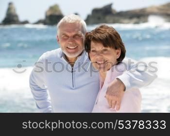 Old couple strolling along the beach
