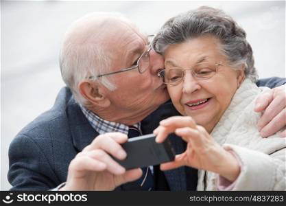 old couple taking a self portrait