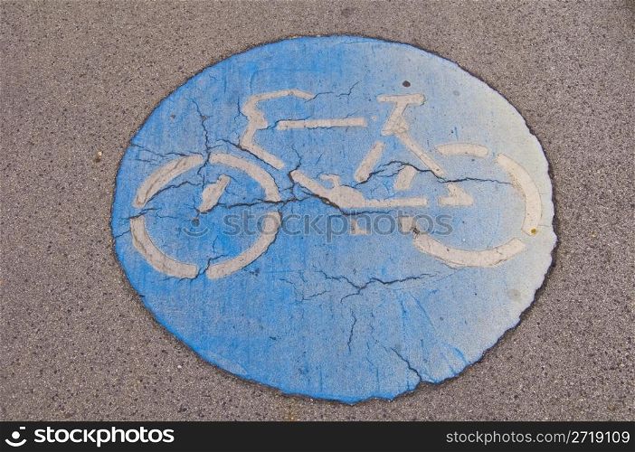 old cracking symbol for a bikeway on the ground