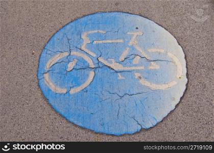 old cracking symbol for a bikeway on the ground