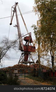 Old crane and logs in Medvezshegorsk, Karelia, Russia
