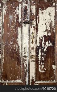 Old cupboard with cracked painted doors, texture of weathered cracked paint background texture. Old cupboard with cracked painted doors, texture of weathered cracked paint