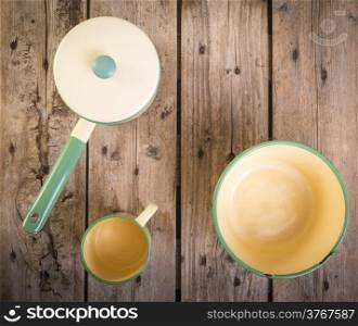 Old cups and saucepan in a retro kitchen table setting