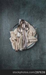 old cutlery, different kinds, on a cloth, top view