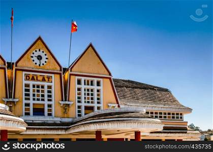 Old Dalat railway station - Vietnam. French colonial style building with yellow facade, Station was designed in 1932 by French architects Moncet and Reveron.