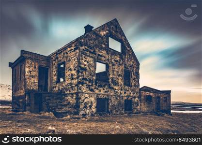 Old damaged house, ruins of building on the wasteland, weathered and abandoned home in Iceland, Scandinavia, Europe. Old damaged house