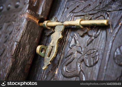 old deadbolt on wooden door