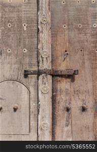 old deadbolt on wooden door