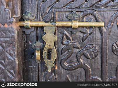 old deadbolt on wooden door