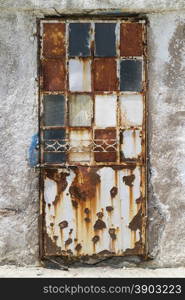 Old decorated rusty door in decay
