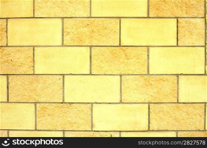 Old dilapidated brick wall of yellow brick