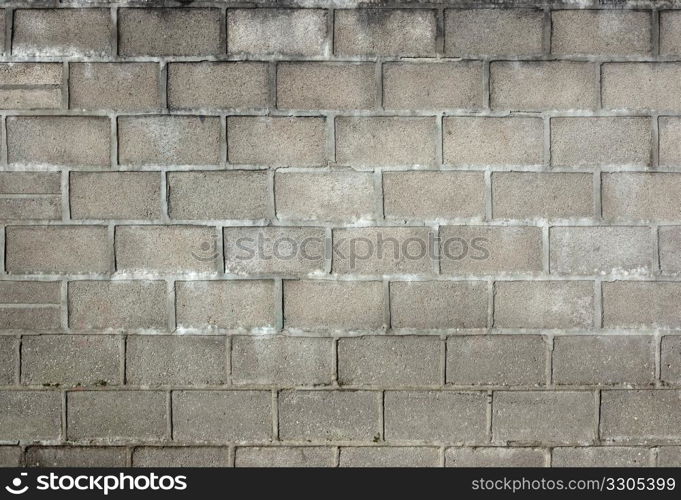 Old dirty gray breeze blocks wall background.